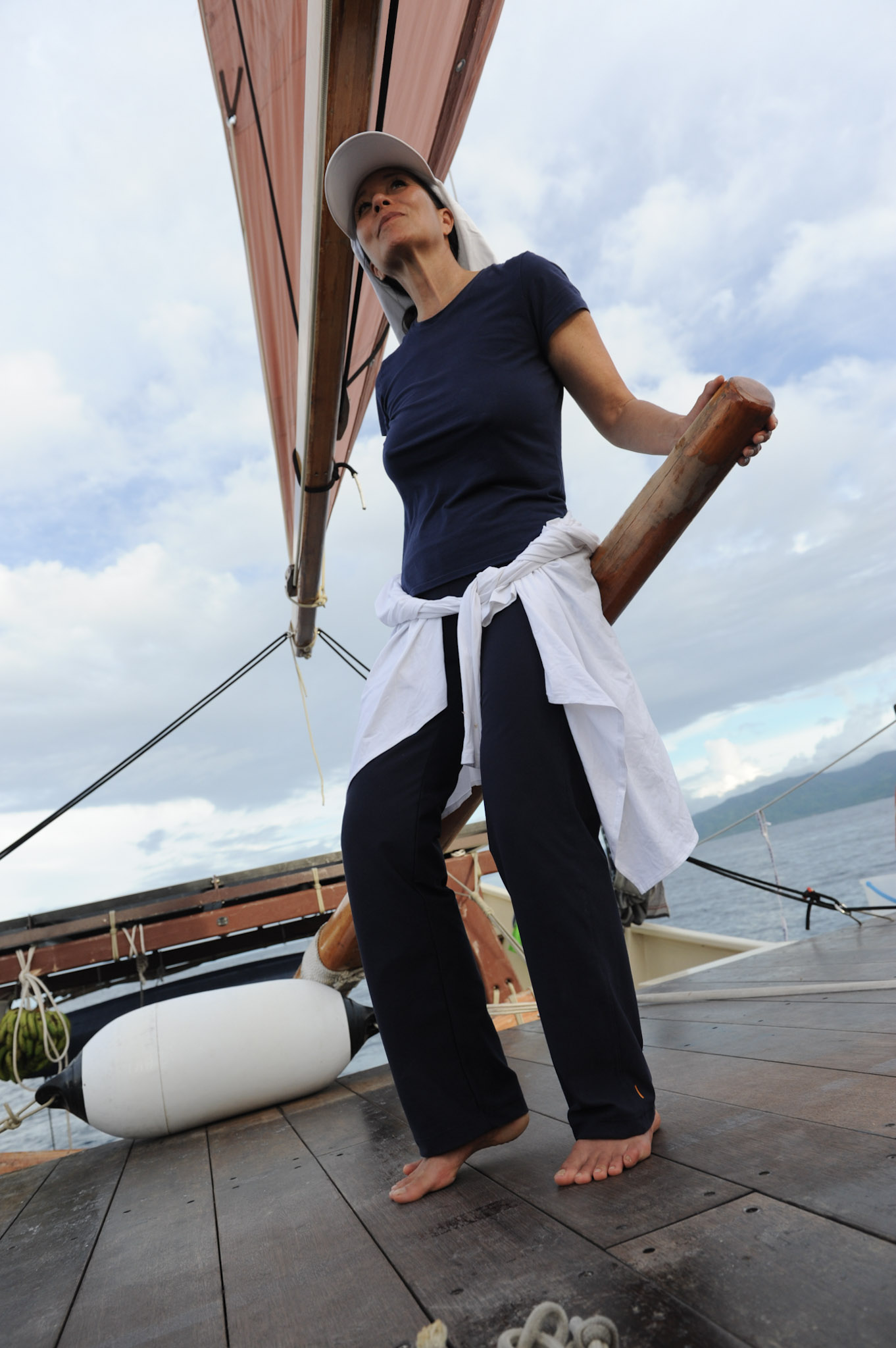 Dr. Elizabeth Lindsey at the helm of a Polynesian voyaging canoe