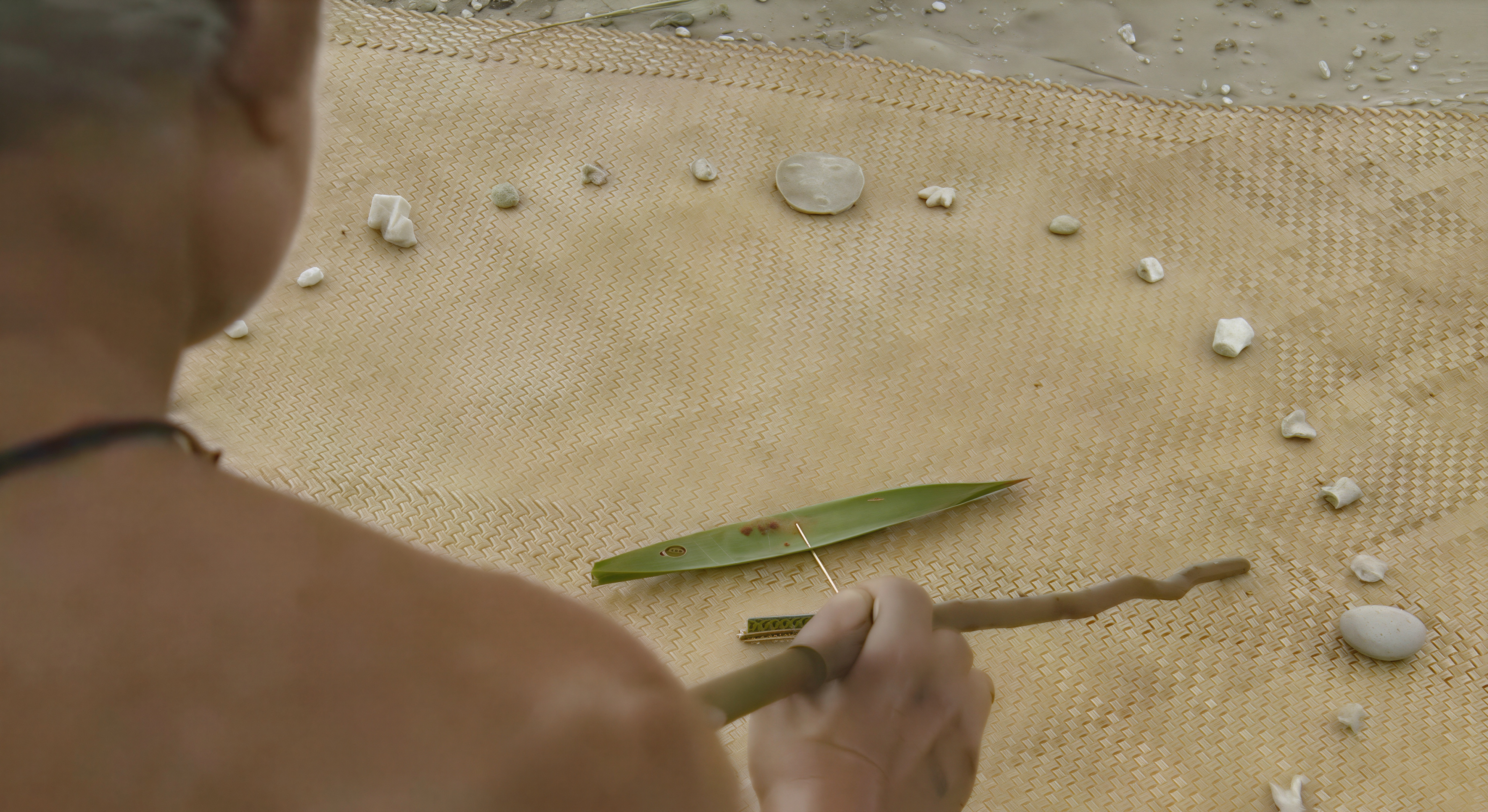 Mau Piailug seated before the star compass laid out on a mat